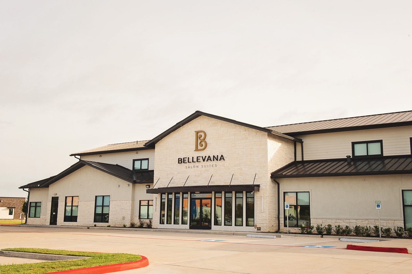 Angled view of the Bellevana Salon Suites front entrance and stone facade