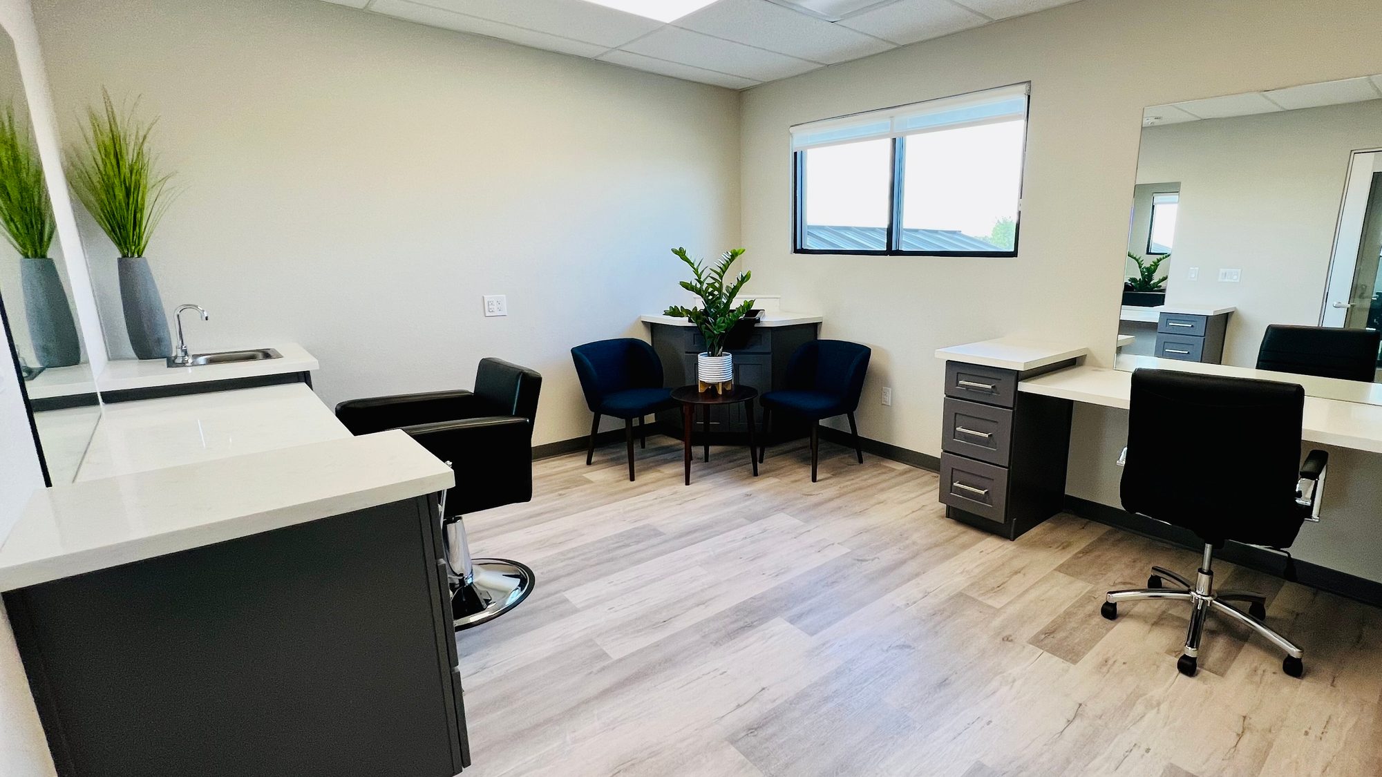 Private Bellevana salon suite with shampoo station, styling chair, mirror, and window